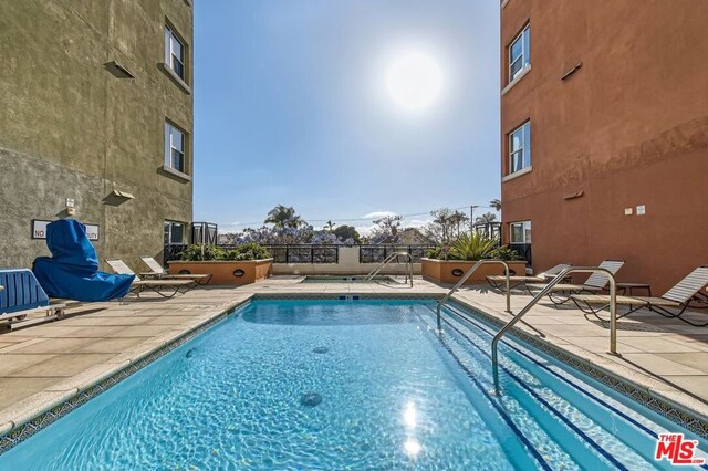 view of swimming pool featuring a patio