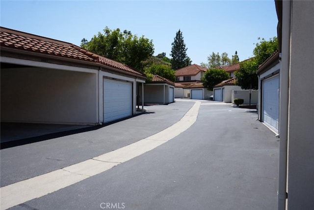 view of patio / terrace featuring a garage and an outbuilding