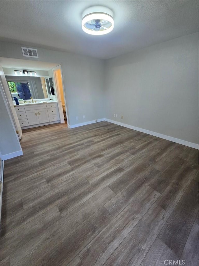 interior space featuring dark wood-type flooring and a textured ceiling