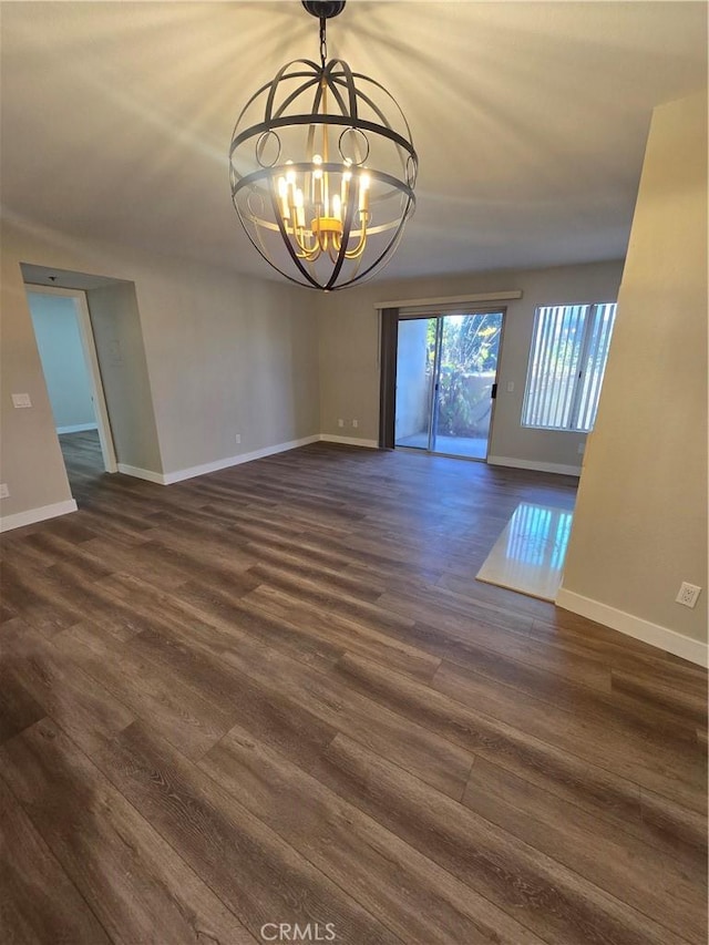 interior space with a chandelier and dark hardwood / wood-style floors