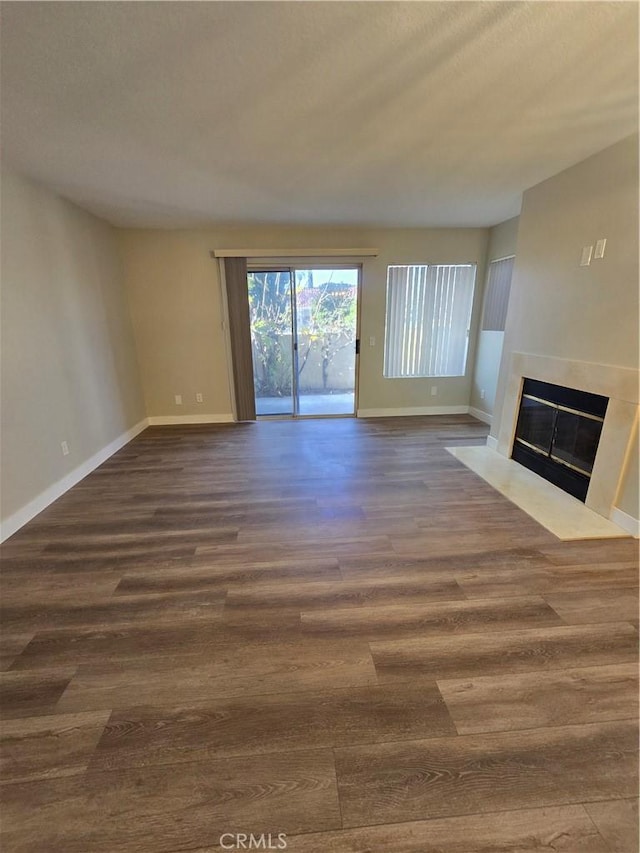 unfurnished living room featuring dark wood-type flooring