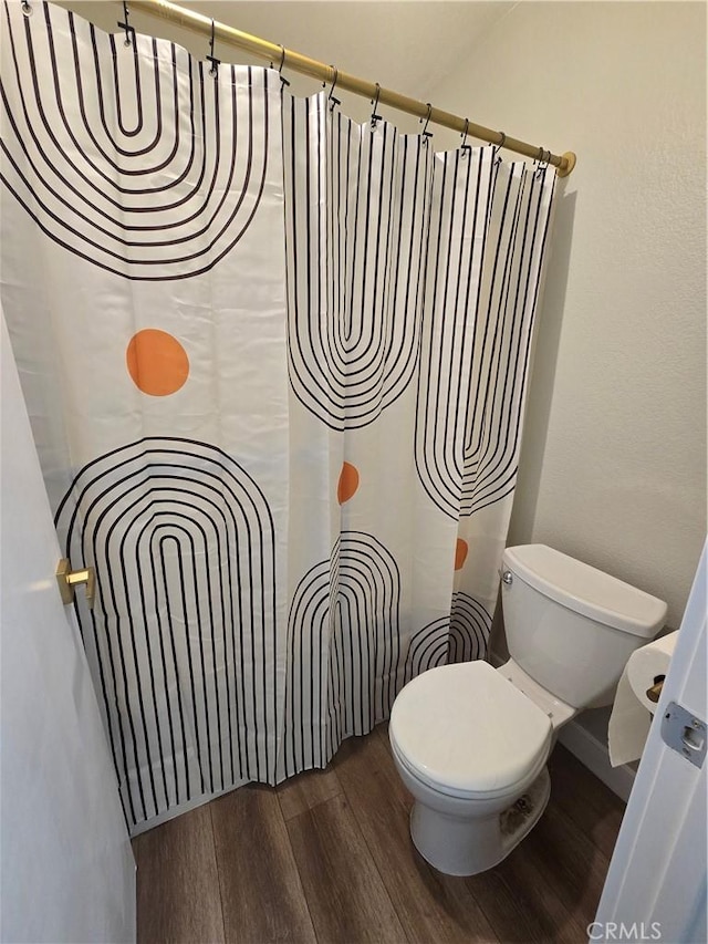 bathroom with toilet and hardwood / wood-style floors