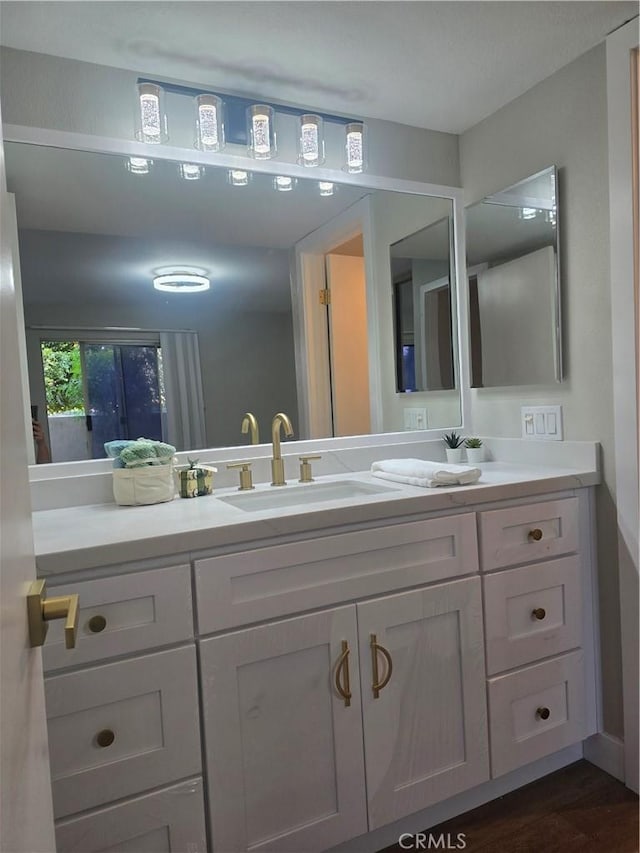 bathroom featuring hardwood / wood-style flooring and vanity