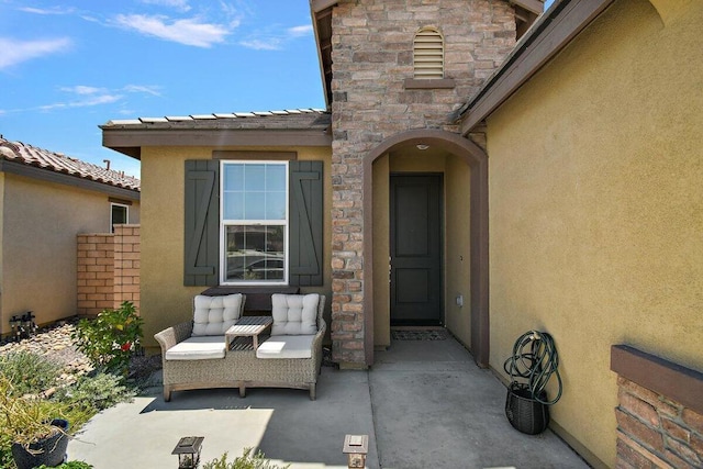 entrance to property with a patio area