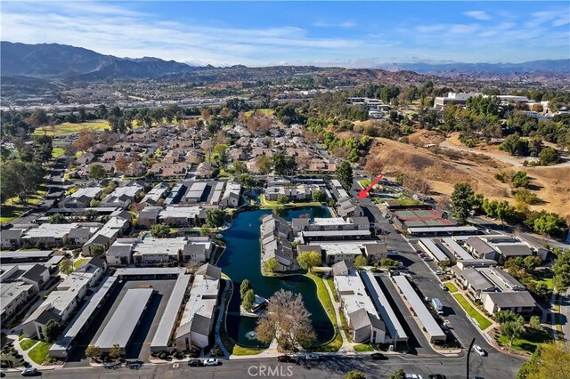 birds eye view of property with a water and mountain view