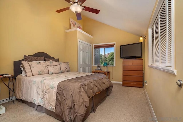 bedroom with ceiling fan, light colored carpet, and vaulted ceiling