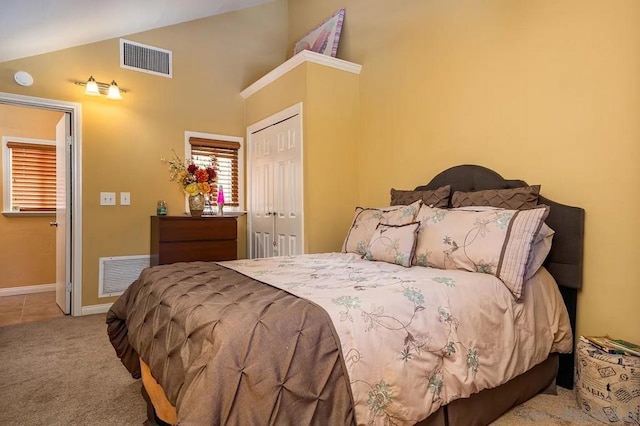 bedroom featuring light carpet, a closet, and lofted ceiling