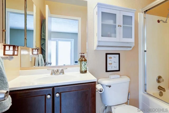 full bathroom featuring toilet, enclosed tub / shower combo, and vanity