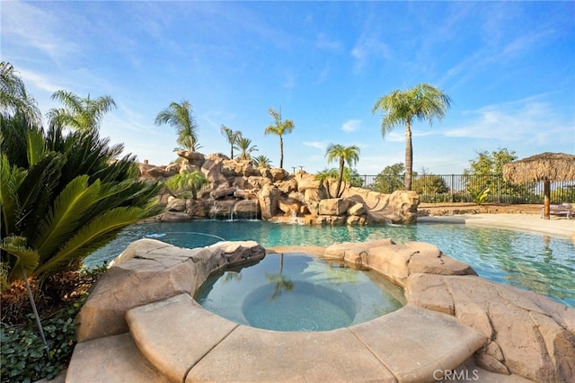 view of swimming pool featuring an in ground hot tub