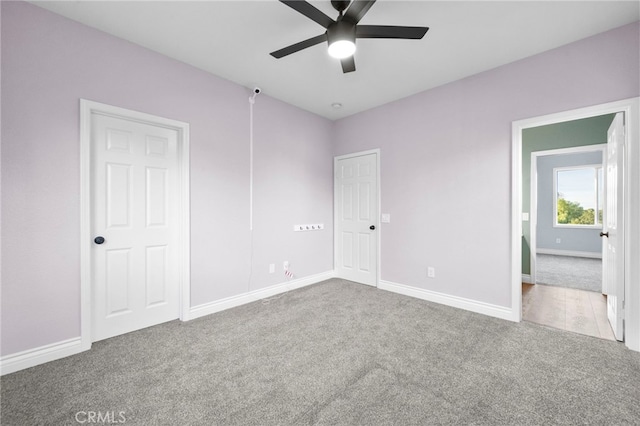 unfurnished bedroom with ceiling fan and carpet floors