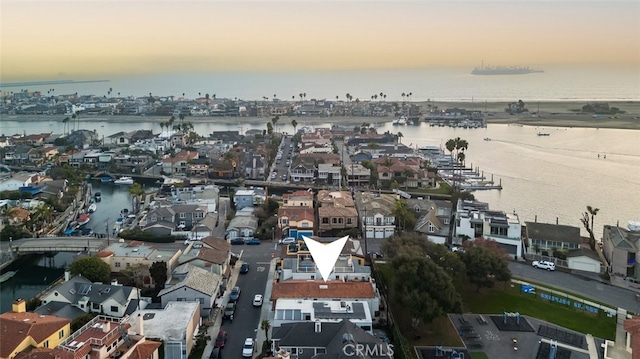 aerial view at dusk with a water view