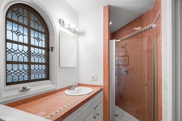 bathroom with an enclosed shower and vanity