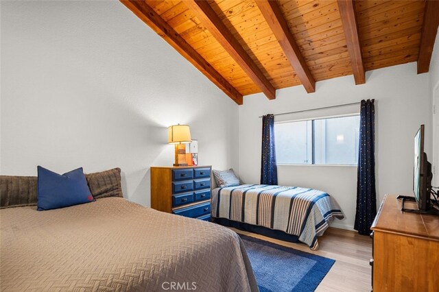 bedroom featuring wood ceiling, light hardwood / wood-style floors, and vaulted ceiling with beams