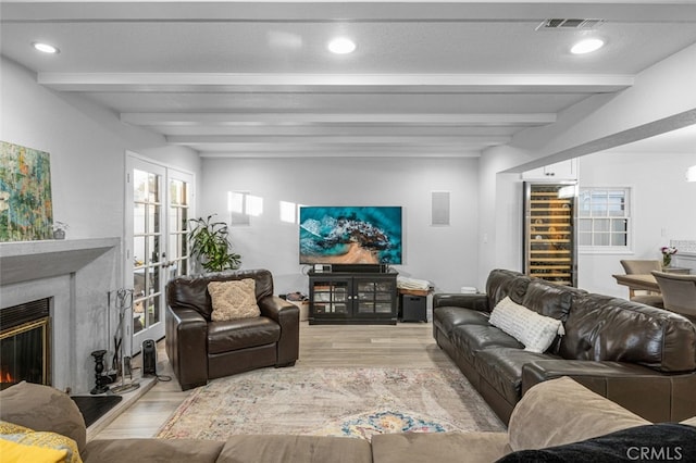 living room featuring light hardwood / wood-style floors and beam ceiling