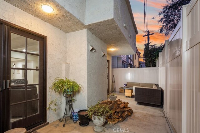 patio terrace at dusk featuring an outdoor hangout area