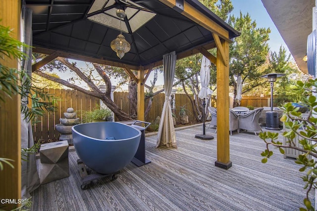 wooden terrace featuring a gazebo