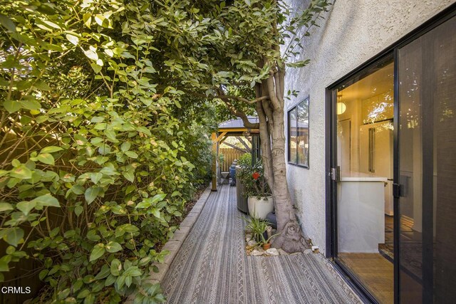 wooden terrace featuring a gazebo