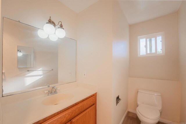 bathroom featuring toilet and vanity