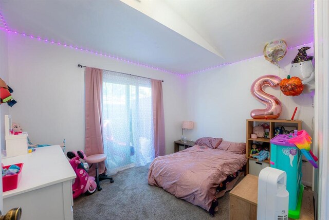 carpeted bedroom with lofted ceiling