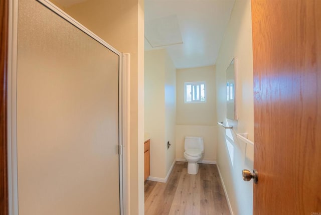 bathroom with toilet, a shower with door, hardwood / wood-style floors, and vanity