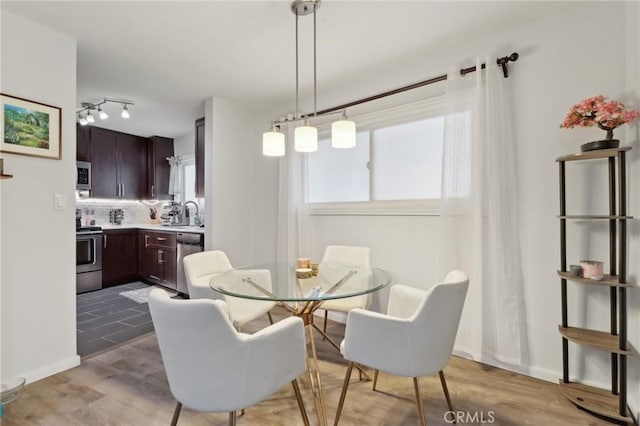 dining room with light hardwood / wood-style flooring and sink