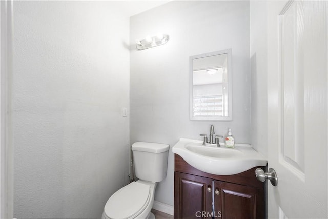 bathroom featuring toilet and vanity