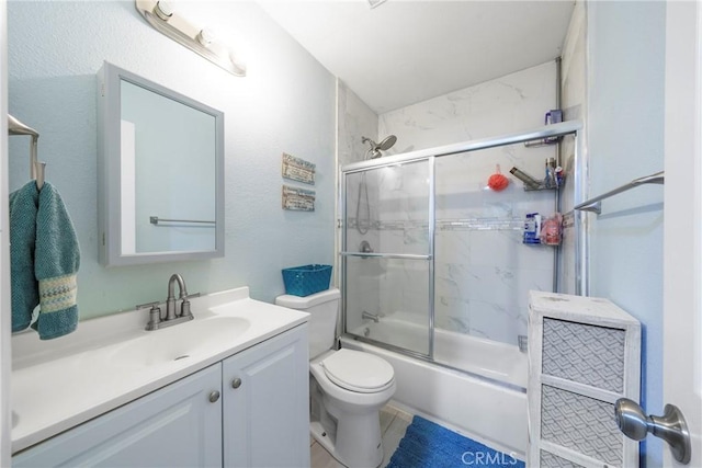 full bathroom featuring bath / shower combo with glass door, toilet, and vanity