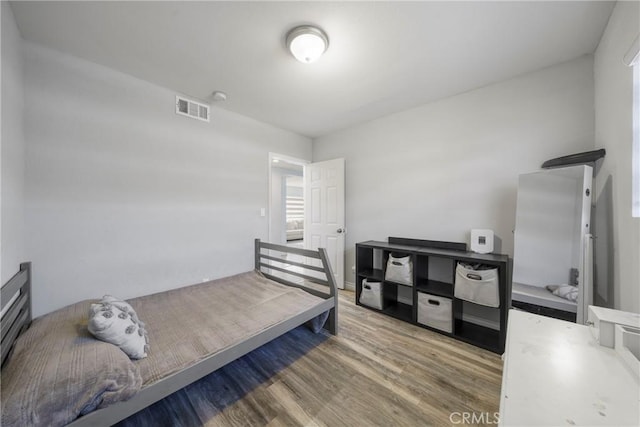 bedroom with hardwood / wood-style flooring