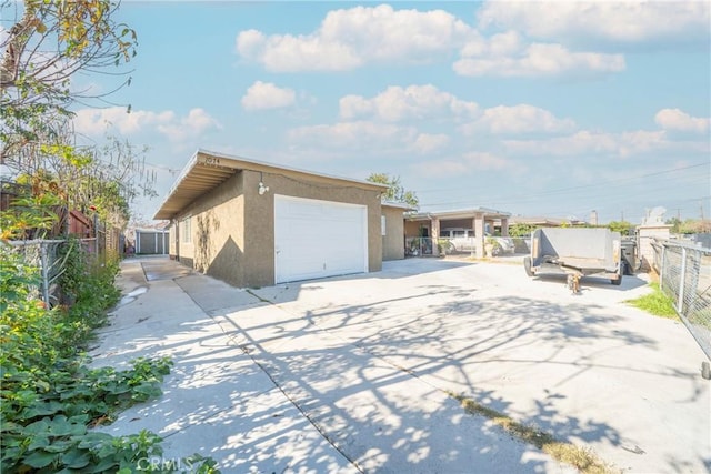 view of property exterior featuring a garage and an outbuilding