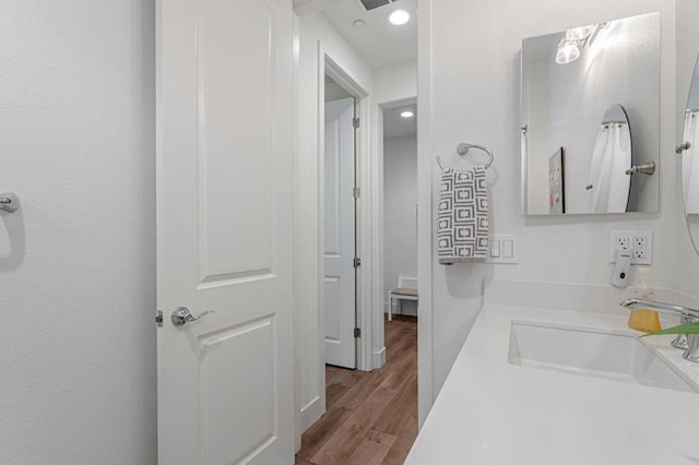 bathroom featuring vanity and hardwood / wood-style floors