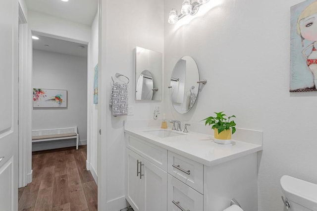 bathroom featuring vanity, hardwood / wood-style flooring, and toilet