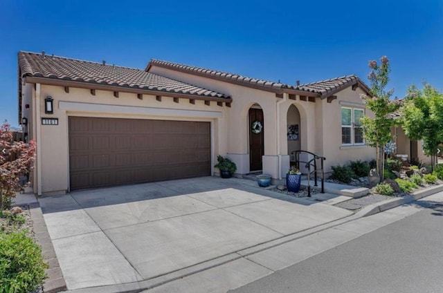 mediterranean / spanish home featuring a garage