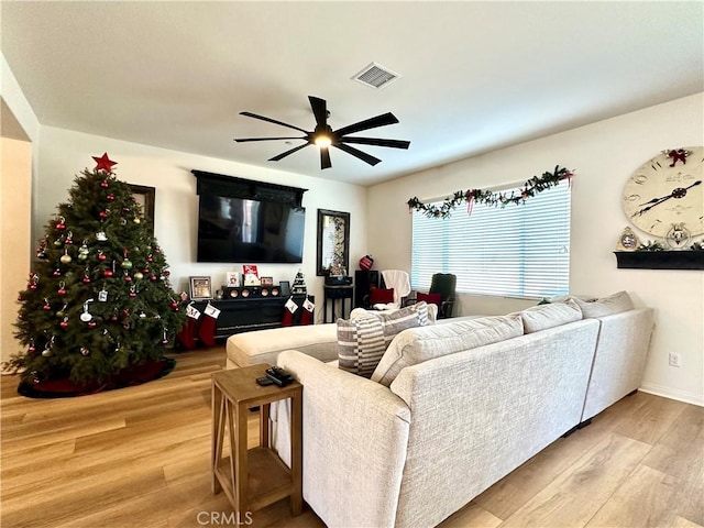 living room featuring hardwood / wood-style flooring and ceiling fan