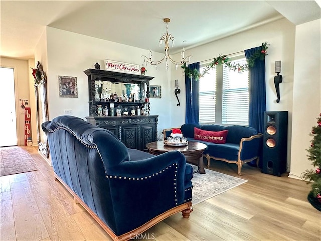 living room featuring a notable chandelier, bar, and hardwood / wood-style floors