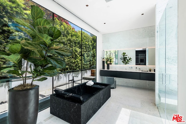 bathroom with floor to ceiling windows and tasteful backsplash