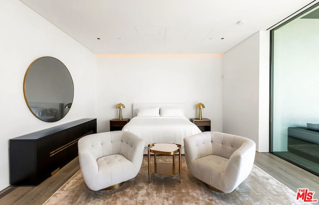 bedroom with floor to ceiling windows and wood-type flooring