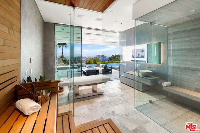 bathroom featuring wood walls and expansive windows