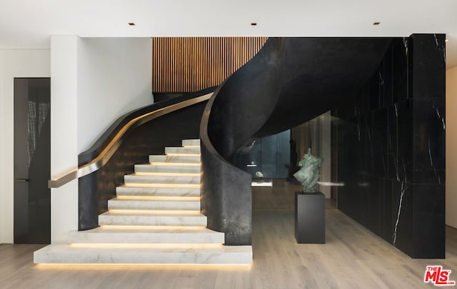 stairs with hardwood / wood-style flooring