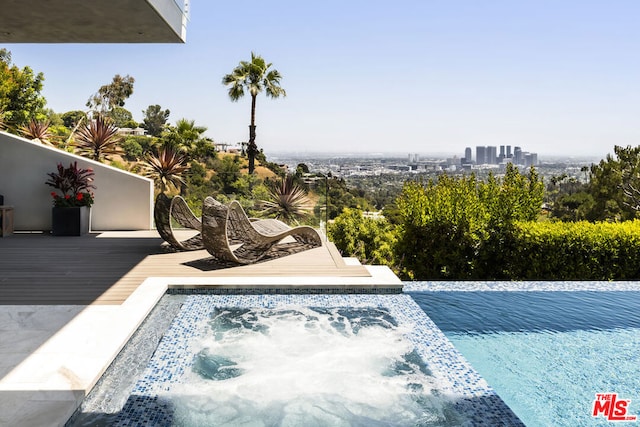 view of pool featuring a wooden deck and a hot tub