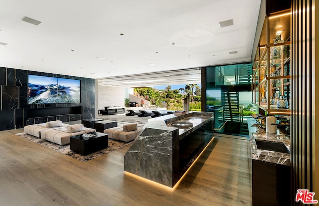 living room with expansive windows and hardwood / wood-style flooring