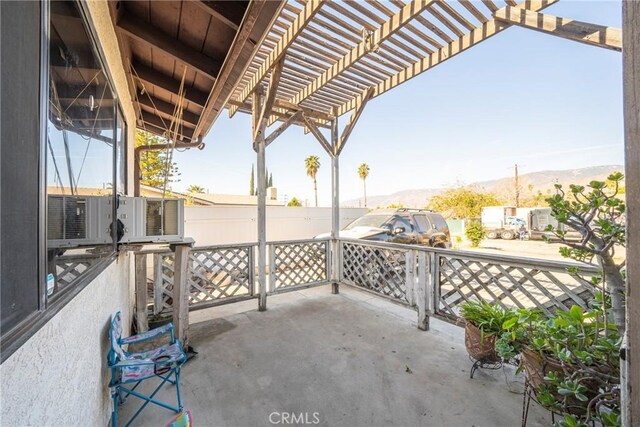 view of patio / terrace with a mountain view and a pergola