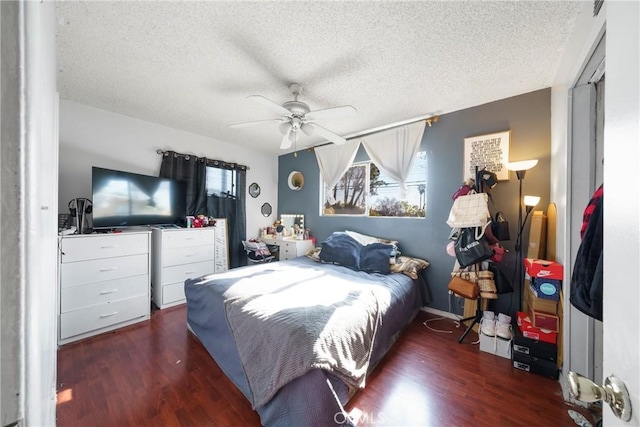 bedroom featuring a textured ceiling, ceiling fan, and dark hardwood / wood-style floors