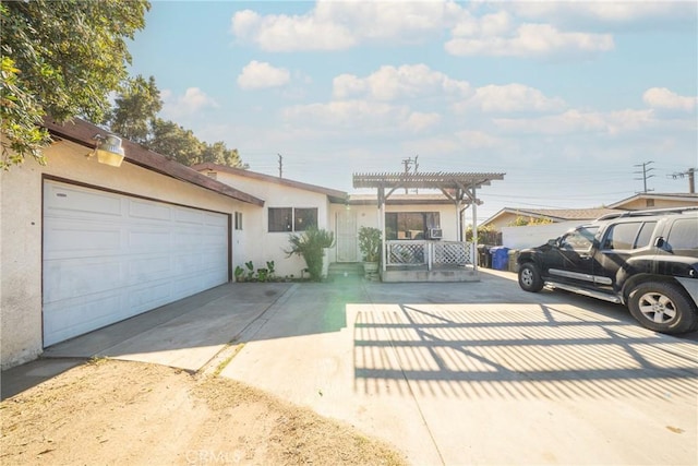 view of front facade with a garage and a pergola