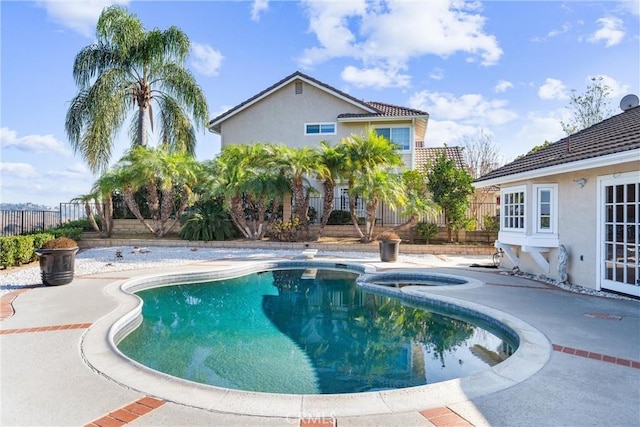 view of pool with an in ground hot tub and a patio