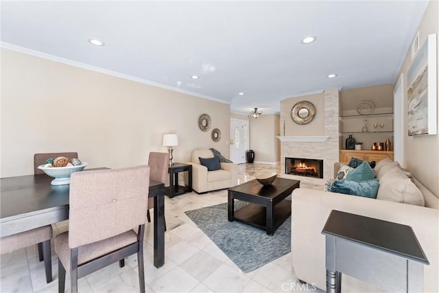 living room with ornamental molding and a fireplace