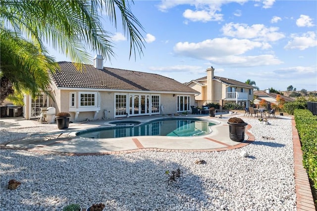 view of swimming pool with a patio area, grilling area, and an in ground hot tub