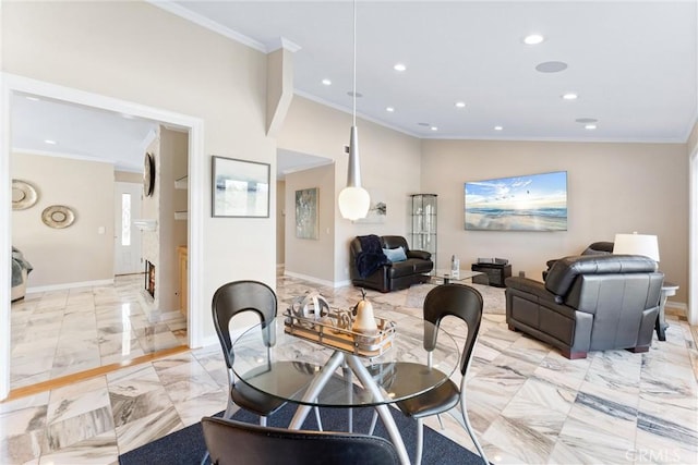 dining room featuring vaulted ceiling and ornamental molding