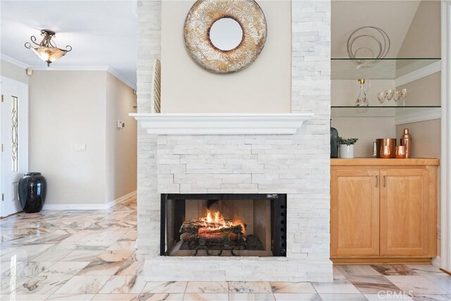 room details featuring crown molding and a fireplace