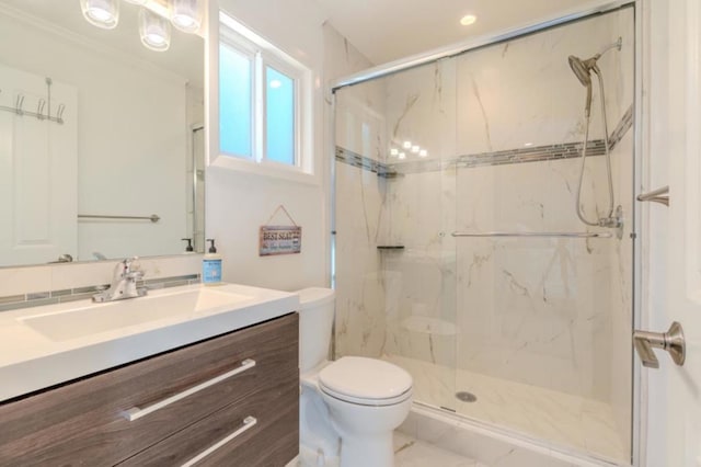 bathroom with toilet, walk in shower, and vanity