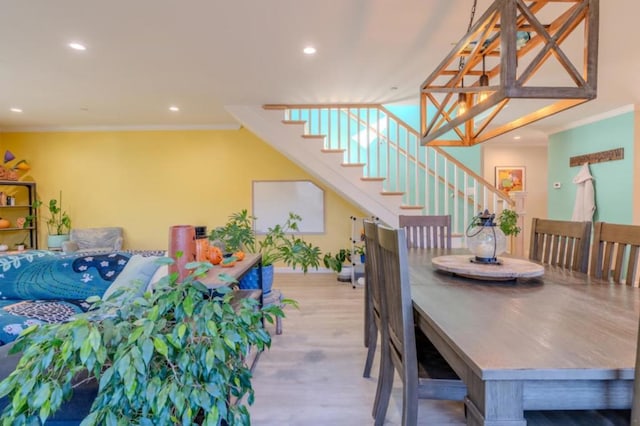 dining area featuring light hardwood / wood-style floors and crown molding